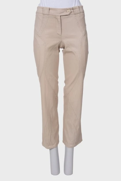 Бежевые брюки с асимметричними швами